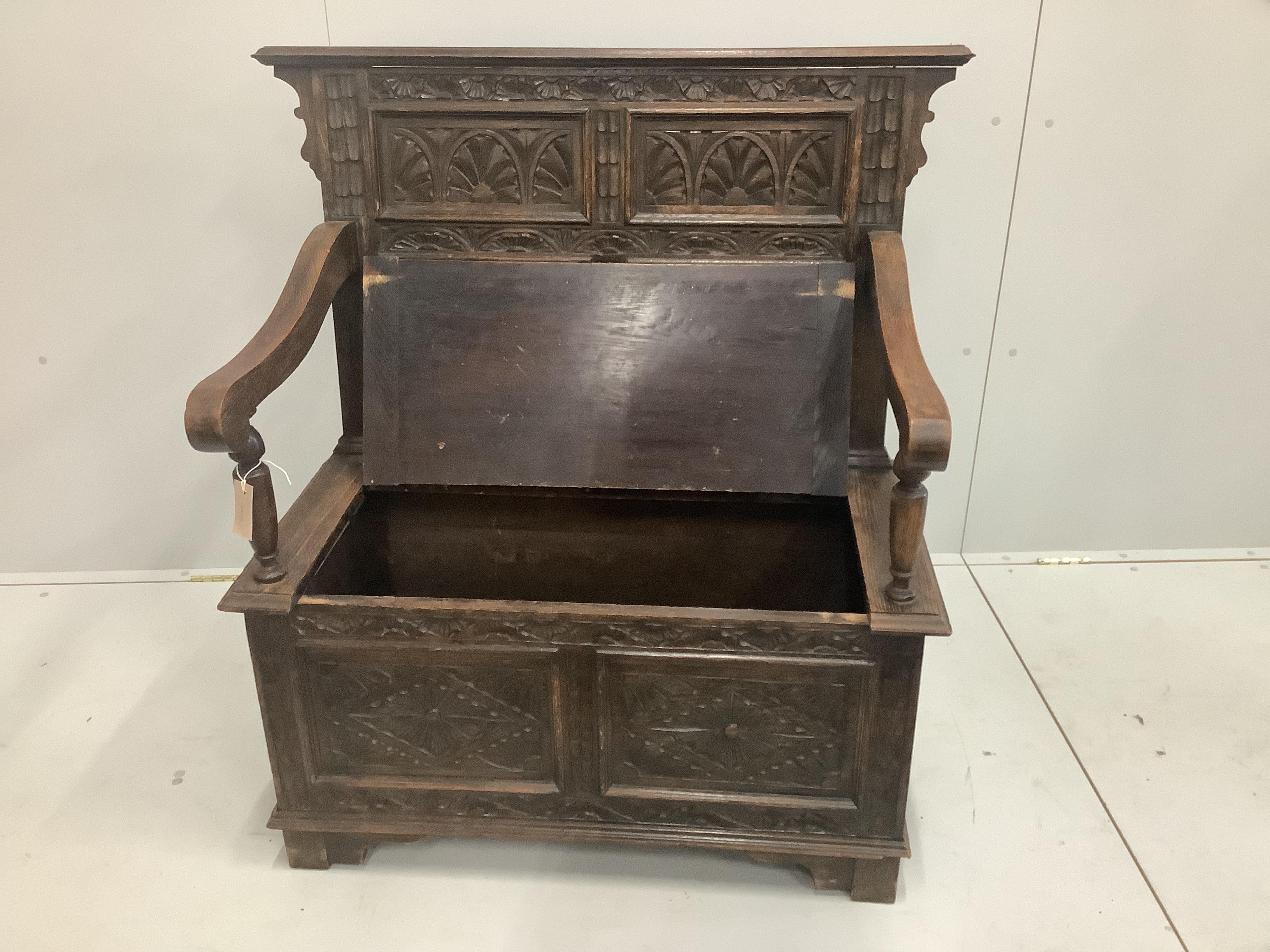 A small carved oak monk's bench, circa 1900, width 100cm, height 108cm